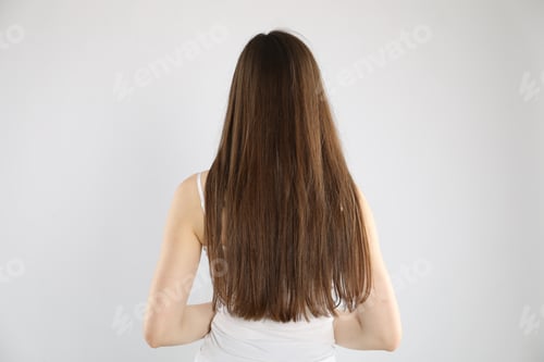 Preview: Woman with long hair on light background, back view