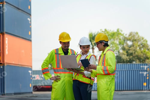 Preview: Construction workers review plans in a shipping yard during daylight hours