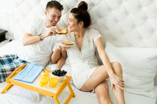 Preview: Couple having a breakfast in bed
