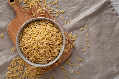 Preview: Organic Dried Orzo Pasta in a Bowl, top view. Space for text.