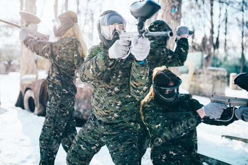 Preview: Paintball players in uniform and masks poses