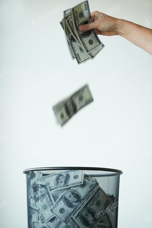 Preview: Dont throw your life savings away - Bank. Someone throwing money away in a trash can.