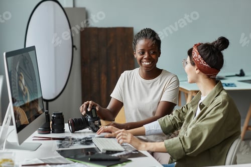 Preview: Team of Female Photographers Discussing Pictures