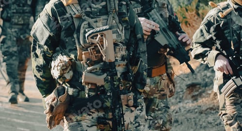 Preview: Soldiers walking with rifles and tactical gear during a military operation