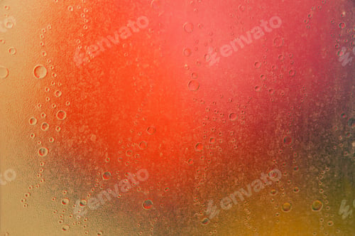 Preview: water drops on glass abstract background. Focus on the drops on the glass and the colored spots
