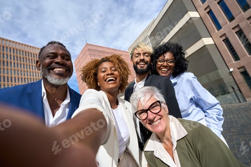 Preview: Happy multi-ethnic colleagues taking a selfie outdoors