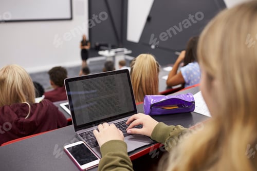 Preview: Female student using laptop at a university lecture