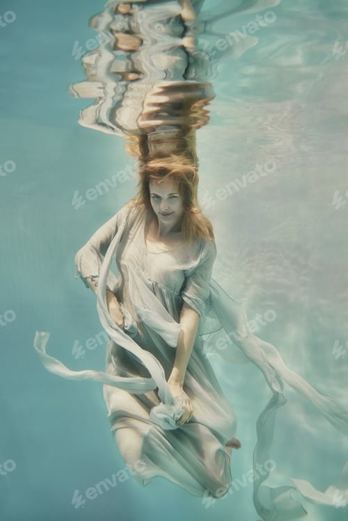 Preview: A Girl In An Airy Light Dress Swims Underwater As If Flying In Zero Gravity