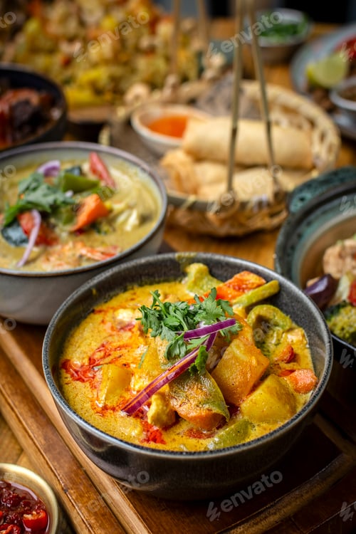 Preview: mix of traditional thai curries on restaurant table in phuket thailand