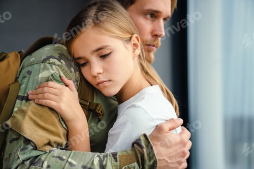 Preview: Masculine sad military man hugging her upset daughter indoors
