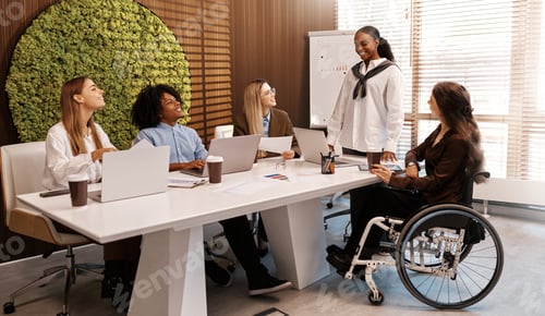 Preview: Diverse business team in meeting with disabled coworker