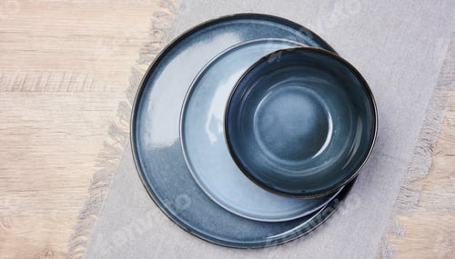 Preview: Empty blue round ceramic plate on the table, top view