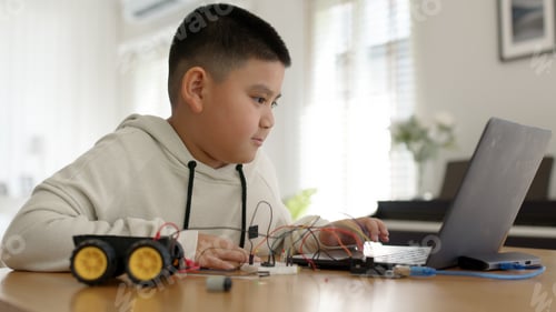 Preview: Young asia student remotely learn online at home in coding robot car