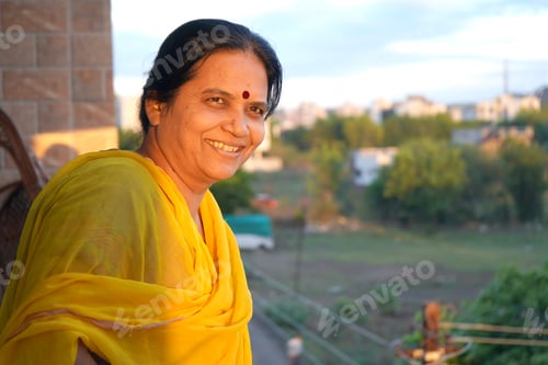 Preview: Portrait of happy Indian woman at her home