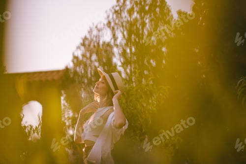 Preview: Young beautiful woman with short hair wearing fashionable trendy clothes at sunset.