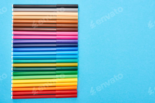 Preview: Top view of set of color felt-tip pens isolated on blue