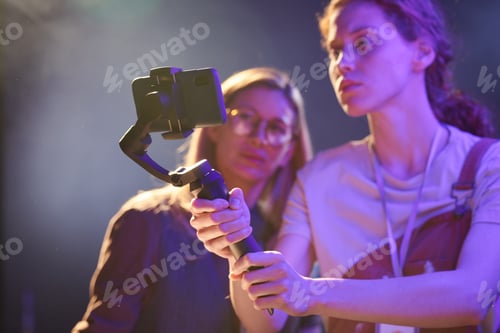 Preview: Women filming videos via smartphone on set