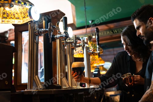 Preview: Bartender pouring stout beer in irish pub