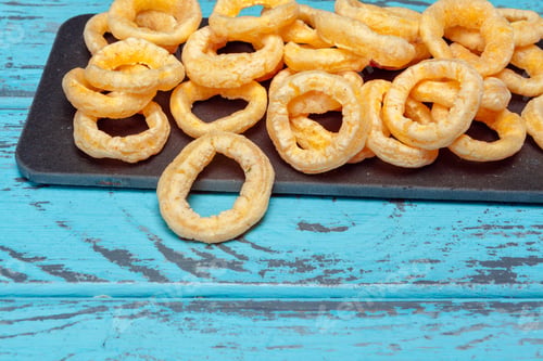 Preview: Pile of crispy onion rings on wooden background