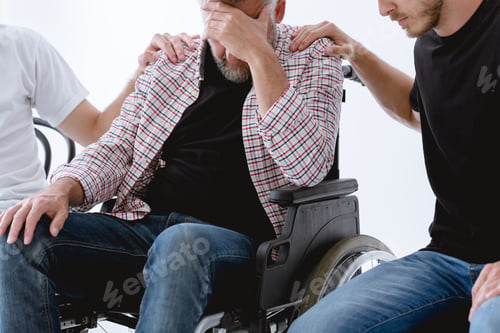 Preview: Friends supporting injured man on wheelchair during psychotherapy for people with ptsd