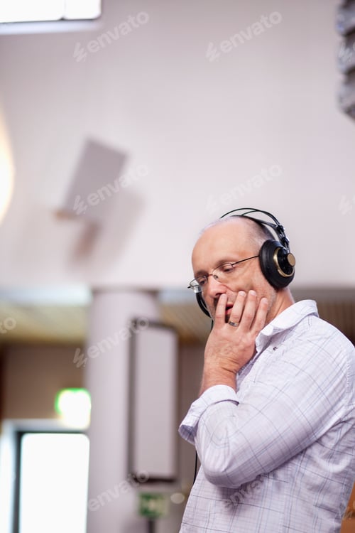 Preview: Thoughtful creative businessman listening music at office