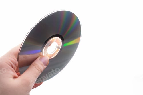 Preview: Closeup of fingers holding a CD Rom is isolated with a white background