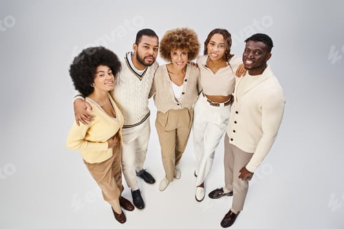 Preview: top view of happy african american friends bonding and hugging on grey background, Juneteenth