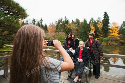 Preview: Girl photographing multi generation family