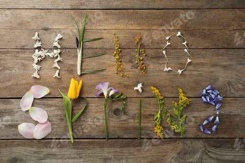 Preview: Words HELLO SPRING made of fresh flowers on wooden table, flat lay