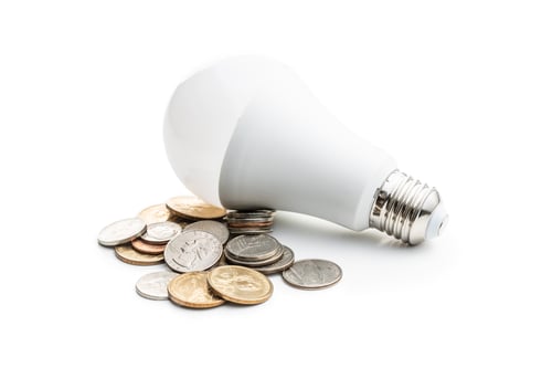 Preview: Energy saving light bulb. LED light bulb and dollar coins.