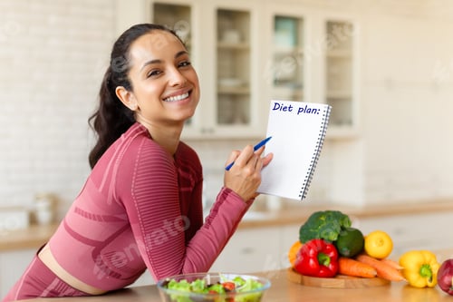 Preview: Smiling Fit Woman Posing With Diet Plan In Modern Kitchen