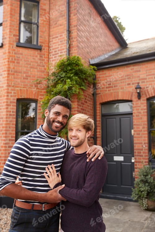 Preview: Portrait Of Excited Gay Male Couple Standing Outside New Home On Moving Day Together