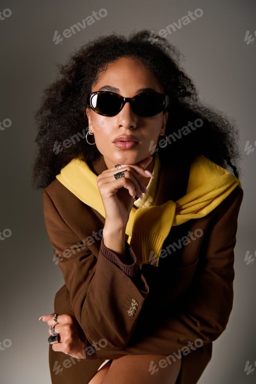 Preview: Elegant african american woman showcases autumn fashion in a stylish studio setting