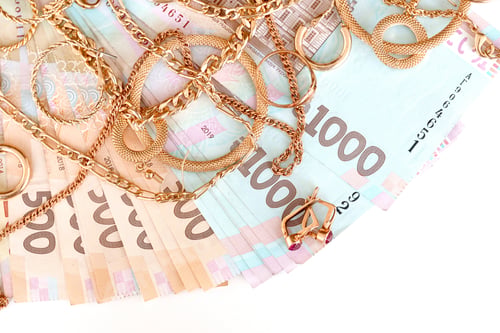 Preview: Many expensive golden jewerly rings, earrings and necklaces with big amount of money bills