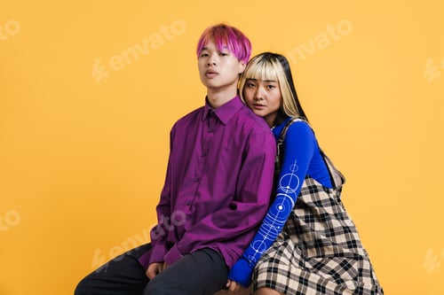 Preview: Asian couple with multicolored hair sitting and looking at camera