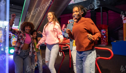Preview: Group of Friends Dancing and Having Fun at Arcade