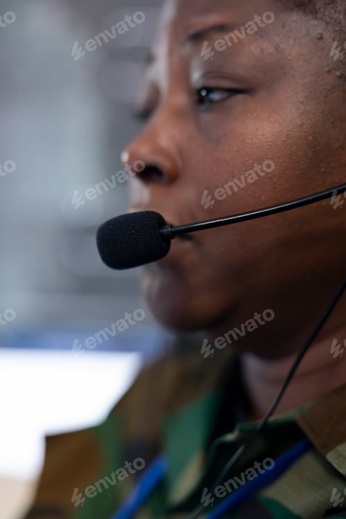 Preview: Trained woman operator examining military surveillance footage on CCTV