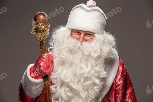 Preview: Happy Santa Claus In Eyeglasses With Staff Looking At Camera On Black Background