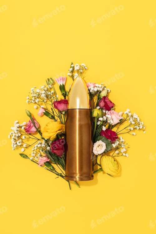 Preview: Pacifism and non-violence movement. Bullet and bunch of different flowers against yellow background.