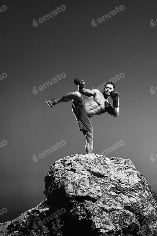 Preview: Monochrome shots of a fierce male boxer training outdoors