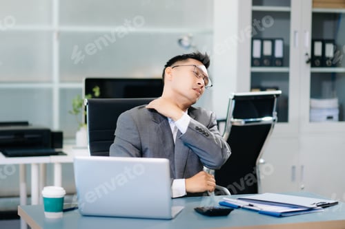 Preview: Tired businessman suffering neck pain from office syndrome, feeling muscle strain and