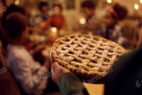 Preview: Close up of woman serving her family Thanksgiving pie for dessert.