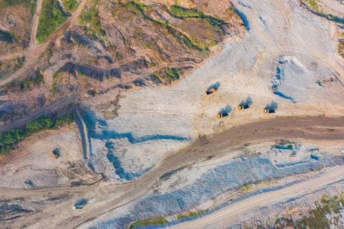 Preview: Machine excavator trucks dig coal mining or ore in quarry with mountain hills. Factory industry.