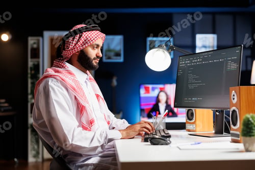 Preview: Muslim developer writes code on computer