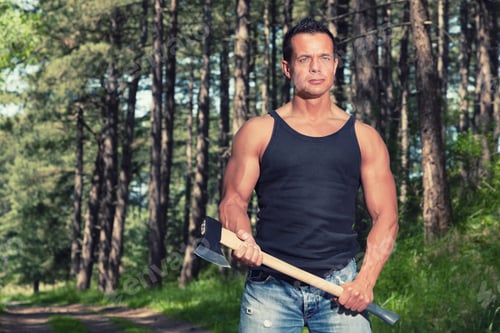 Preview: Muscled Man With Black Shirt And Axe In Forest.