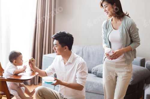Preview: Young parents feeding baby