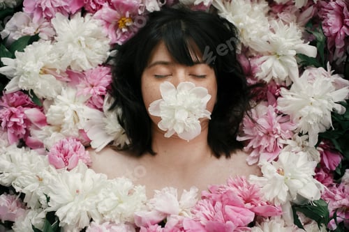 Preview: Beautiful brunette girl in many pink and white flowers