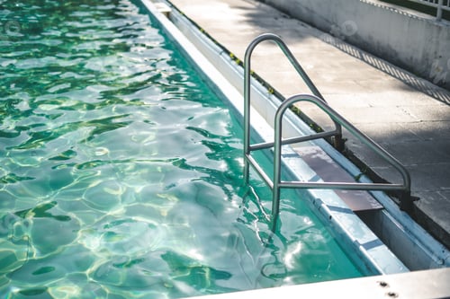 Preview: Bright blue swimming pool on a sunny day
