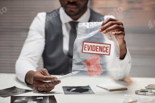 Preview: Detective holding plastic bag with evidence during interrogation