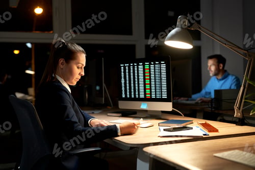 Preview: Caucasian woman and man working late at the office